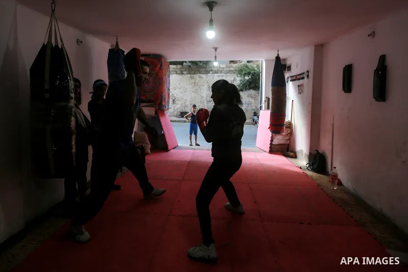Palestinian coach Osama Ayoub trains girls in boxing in Gaza City, on August 22, 2021. Ayoub boxed all over the Arab world and when he returned to Gaza in 2013, he started introducing the sport to Palestinian women, init...