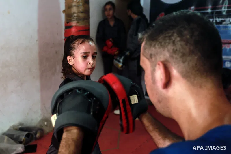 Palestinian coach Osama Ayoub trains girls in boxing in Gaza City, on August 22, 2021. Ayoub boxed all over the Arab world and when he returned to Gaza in 2013, he started introducing the sport to Palestinian women, init...