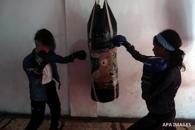Palestinian coach Osama Ayoub trains girls in boxing in Gaza City, on August 22, 2021. Ayoub boxed all over the Arab world and when he returned to Gaza in 2013, he started introducing the sport to Palestinian women, init...