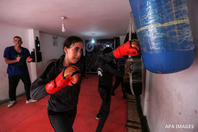 Palestinian coach Osama Ayoub trains girls in boxing in Gaza City, on August 22, 2021. Ayoub boxed all over the Arab world and when he returned to Gaza in 2013, he started introducing the sport to Palestinian women, init...