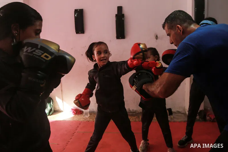 Palestinian coach Osama Ayoub trains girls in boxing in Gaza City, on August 22, 2021. Ayoub boxed all over the Arab world and when he returned to Gaza in 2013, he started introducing the sport to Palestinian women, init...
