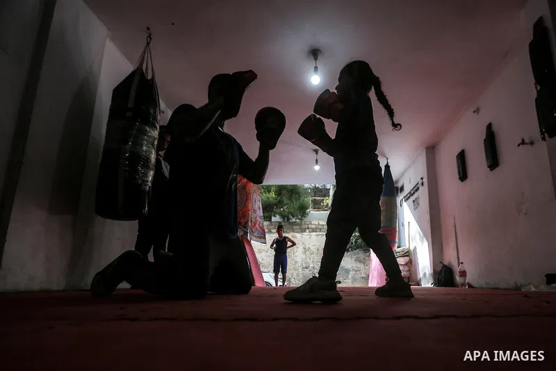 Palestinian coach Osama Ayoub trains girls in boxing in Gaza City, on August 22, 2021. Ayoub boxed all over the Arab world and when he returned to Gaza in 2013, he started introducing the sport to Palestinian women, init...