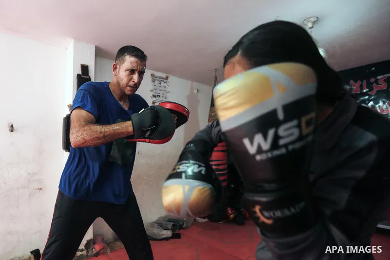 Palestinian coach Osama Ayoub trains girls in boxing in Gaza City, on August 22, 2021. Ayoub boxed all over the Arab world and when he returned to Gaza in 2013, he started introducing the sport to Palestinian women, init...