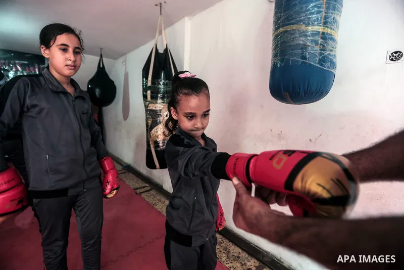 Palestinian coach Osama Ayoub trains girls in boxing in Gaza City, on August 22, 2021. Ayoub boxed all over the Arab world and when he returned to Gaza in 2013, he started introducing the sport to Palestinian women, init...