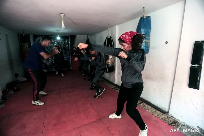 Palestinian coach Osama Ayoub trains girls in boxing in Gaza City, on August 22, 2021. Ayoub boxed all over the Arab world and when he returned to Gaza in 2013, he started introducing the sport to Palestinian women, init...