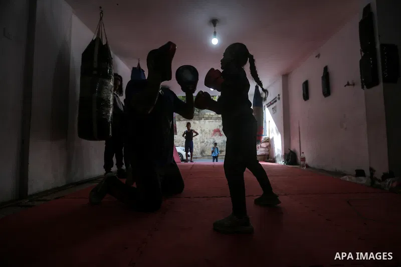 Palestinian coach Osama Ayoub trains girls in boxing in Gaza City, on August 22, 2021. Ayoub boxed all over the Arab world and when he returned to Gaza in 2013, he started introducing the sport to Palestinian women, init...
