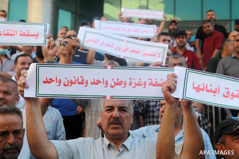 Palestinian military retirees take part in a protest to demand the cancellation of the Mandatory retirement law, in Gaza city, on August 23, 2021. Palestinian Prime Minister Mohammad Shtayyeh previously announced that 6,...