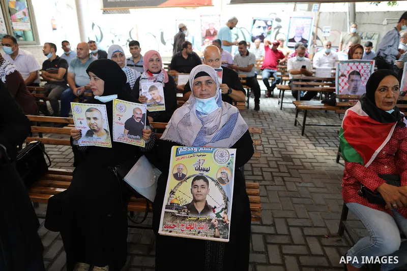 Palestinians take part in a protest to show solidarity with prisoners on hunger strike in Israeli Jails, in front of the headquarters of Red cross in Gaza city on August 23, 2021. Nine Palestinian prisoners in Israeli de...