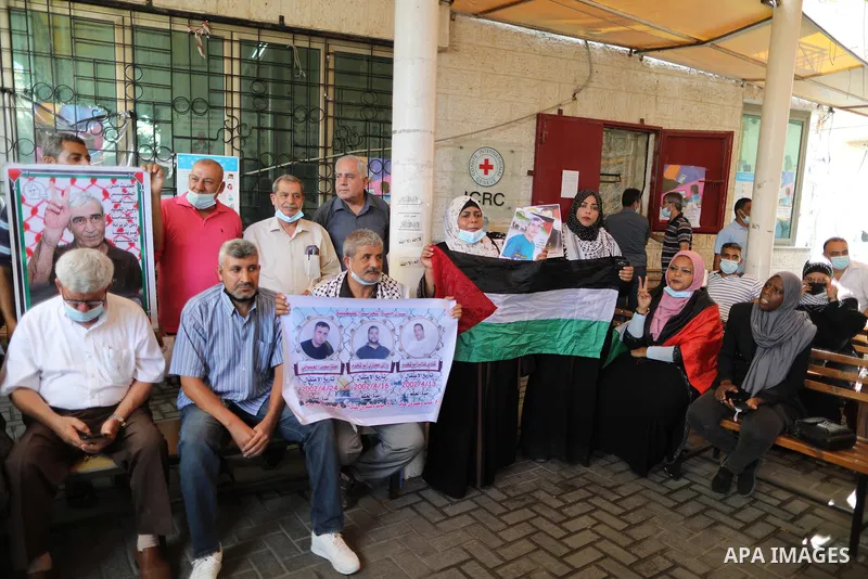 Palestinians take part in a protest to show solidarity with prisoners on hunger strike in Israeli Jails, in front of the headquarters of Red cross in Gaza city on August 23, 2021. Nine Palestinian prisoners in Israeli de...