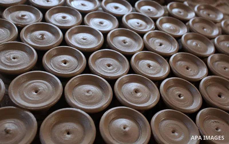 A Palestinian pottery worker makes earthenware vases at a pottery workshop, in Gaza city on August 23, 2021. Pottery is an ancient and traditional craft in Gaza. Local workshops usually produce products such as bowls, pi...