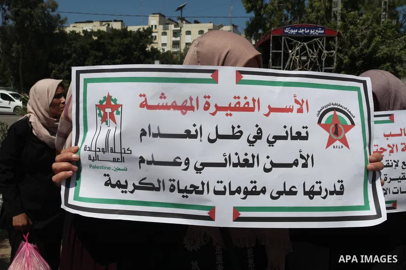 Supporters of the Democratic Front for the Liberation of Palestine, take part in a protest to demand the payment of social affairs allowances, in Gaza city on August 23, 2021. Photo by Youssef Abu Watfa