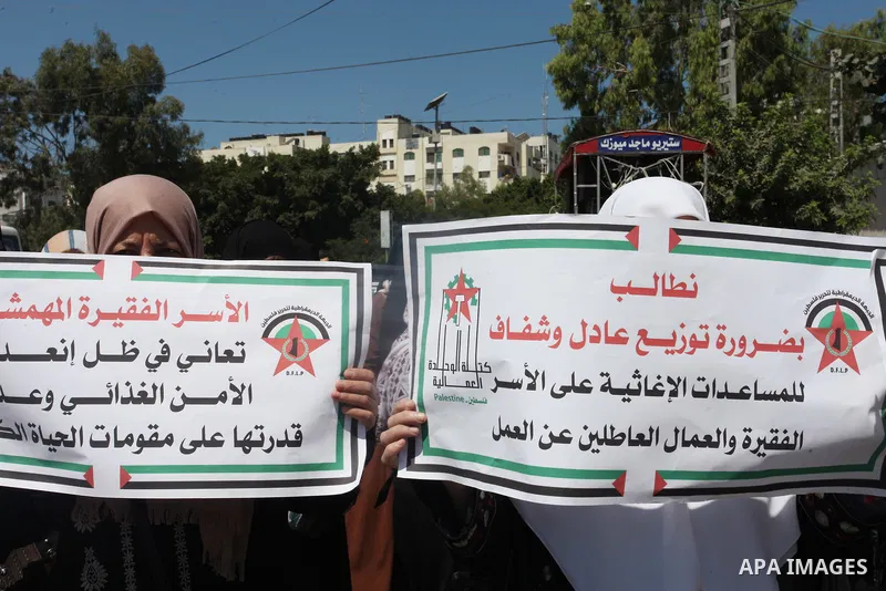 Supporters of the Democratic Front for the Liberation of Palestine, take part in a protest to demand the payment of social affairs allowances, in Gaza city on August 23, 2021. Photo by Youssef Abu Watfa