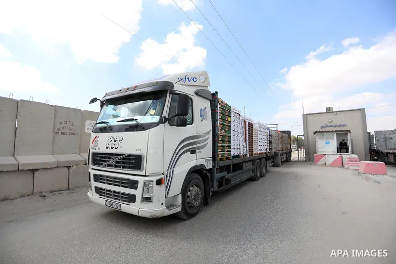 Trucks loaded with goods and fuel enter the Gaza Strip from Israel through the Kerem Shalom crossing in Rafah in the southern Gaza Strip on August 23, 2021. Israel had banned the entry of the construction materials into...