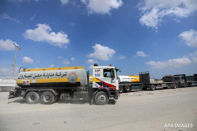 Trucks loaded with goods and fuel enter the Gaza Strip from Israel through the Kerem Shalom crossing in Rafah in the southern Gaza Strip on August 23, 2021. Israel had banned the entry of the construction materials into...