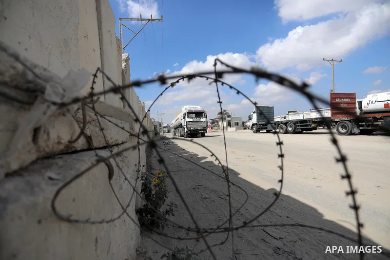 Trucks loaded with goods and fuel enter the Gaza Strip from Israel through the Kerem Shalom crossing in Rafah in the southern Gaza Strip on August 23, 2021. Israel had banned the entry of the construction materials into...