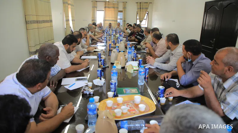 Palestinian members of National and Islamic forces attend a meeting, in Khan Younis in ths southern of Gaza strip, denouncing the Israeli siege of the Palestinian strip, on August 23, 2021. Following an Israeli crackdown...