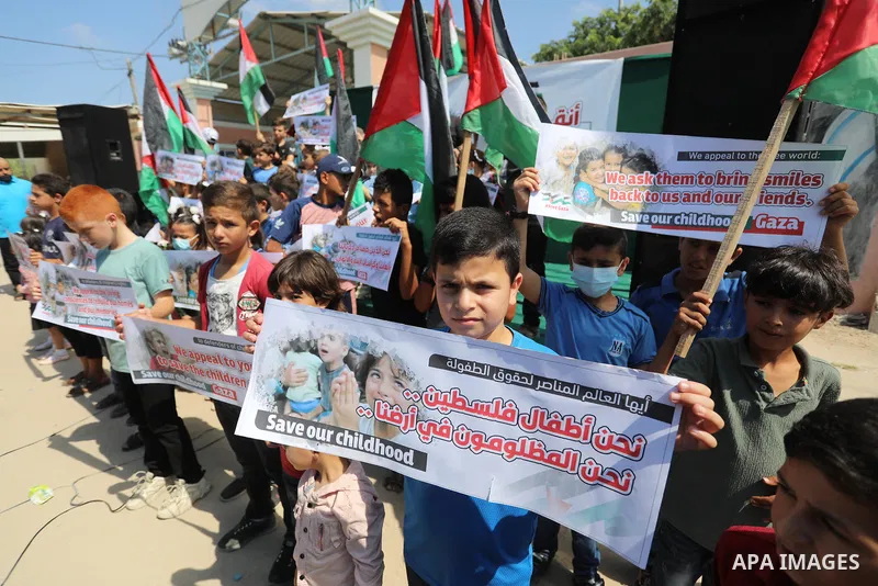 Palestinian children take part in a protest against the Israeli blockade on Gaza Strip, in front of Erez crossing, in Beit Hanoun in the northern Gaza Strip on August 24, 2021. The Israeli blockade of the occupied Gaza S...