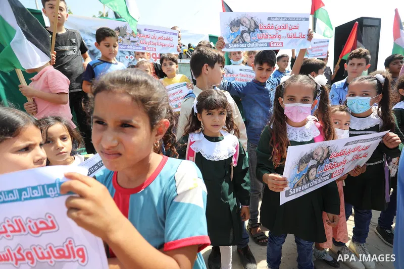 Palestinian children take part in a protest against the Israeli blockade on Gaza Strip, in front of Erez crossing, in Beit Hanoun in the northern Gaza Strip on August 24, 2021. The Israeli blockade of the occupied Gaza S...