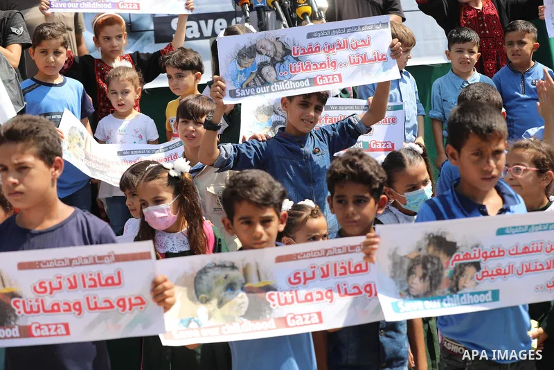Palestinian children take part in a protest against the Israeli blockade on Gaza Strip, in front of Erez crossing, in Beit Hanoun in the northern Gaza Strip on August 24, 2021. The Israeli blockade of the occupied Gaza S...