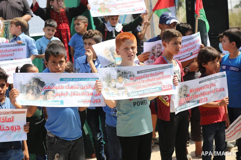 Palestinian children take part in a protest against the Israeli blockade on Gaza Strip, in front of Erez crossing, in Beit Hanoun in the northern Gaza Strip on August 24, 2021. The Israeli blockade of the occupied Gaza S...