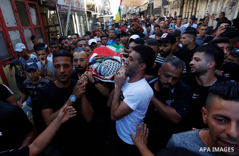 Palestinians attend the funeral of 15-year-old Palestinian Imad Khaled Saleh Hashash at the Balata refugee camp, in the north of the West Bank on August 24, 2021. The Palestinian teenager was killed by Israeli fire early...