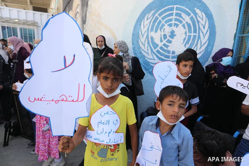 Palestinian children with disabilities hold banners during a protest to demand their right to education in front of the UNRWA gate in Gaza in front of the headquarters United Nations Relief and Works Agency (UNRWA), in G...