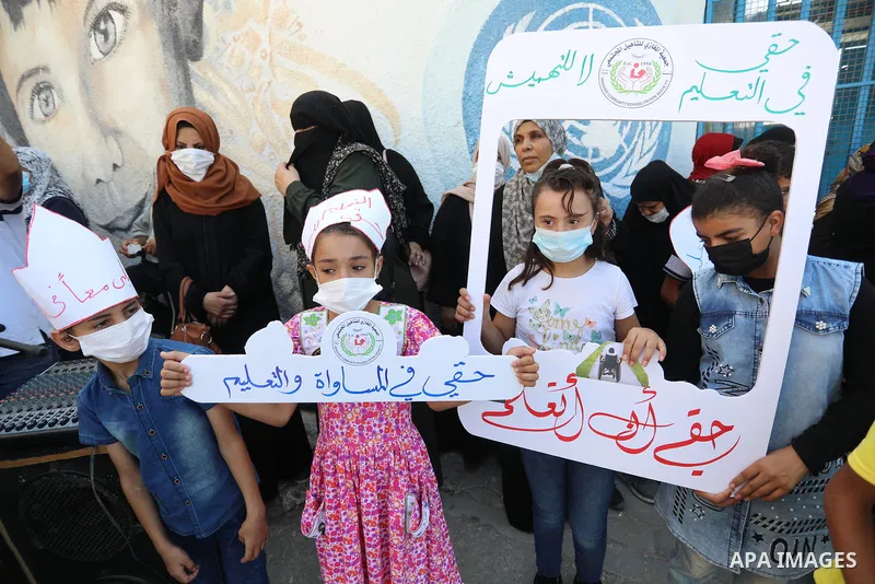 Palestinian children with disabilities hold banners during a protest to demand their right to education in front of the UNRWA gate in Gaza in front of the headquarters United Nations Relief and Works Agency (UNRWA), in G...