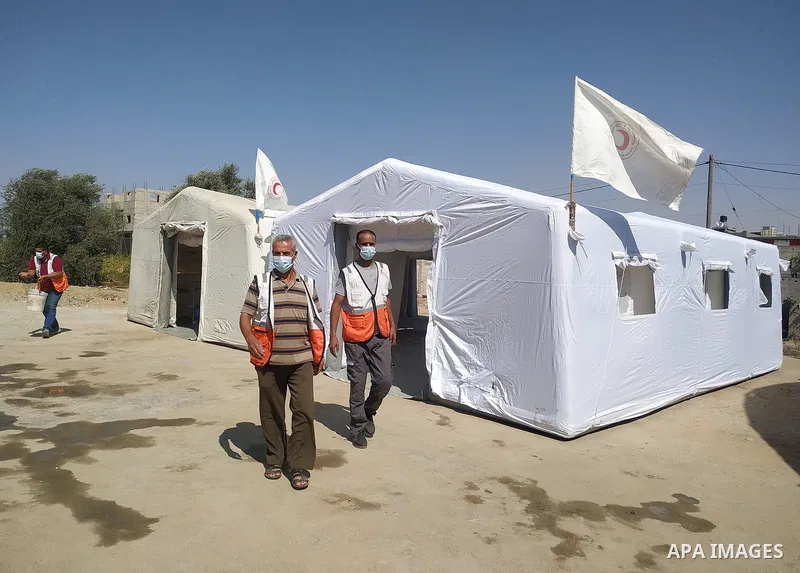 Palestinian Red Crescent teams set up temporary medical centers near the border fence in Khan Yunis, in the southern Gaza Strip, ahead of a protest anti-Israel on August 25, 2021. Photo by Ashraf Amra