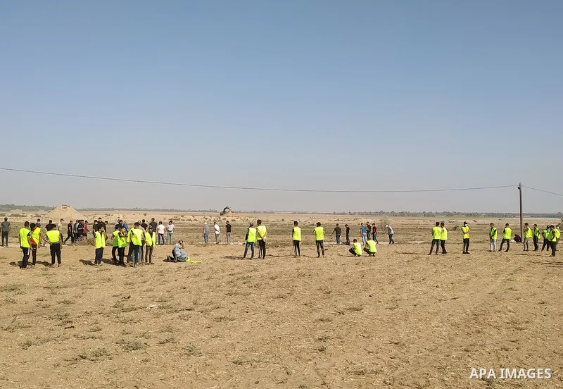 Palestinians gather ahead of a protest anti-Israel near the border fence in Khan Yunis, in the southern Gaza Strip on August 25, 2021. Palestinian groups in Gaza have pledged to continue protests along the border to pres...