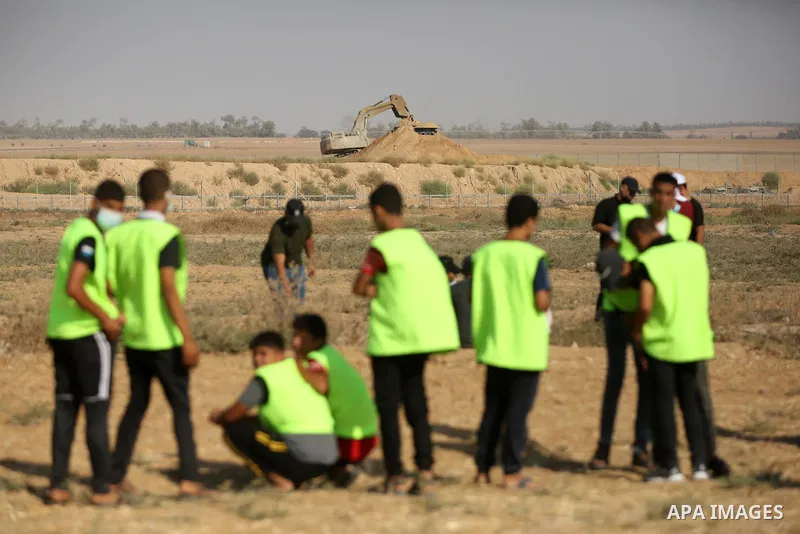 Palestinian demonstrators gather during a protest along the border fence, east of Khan Yunis in the southern Gaza Strip, on August 25, 2021. Palestinian groups in Gaza have pledged to continue protests along the border t...