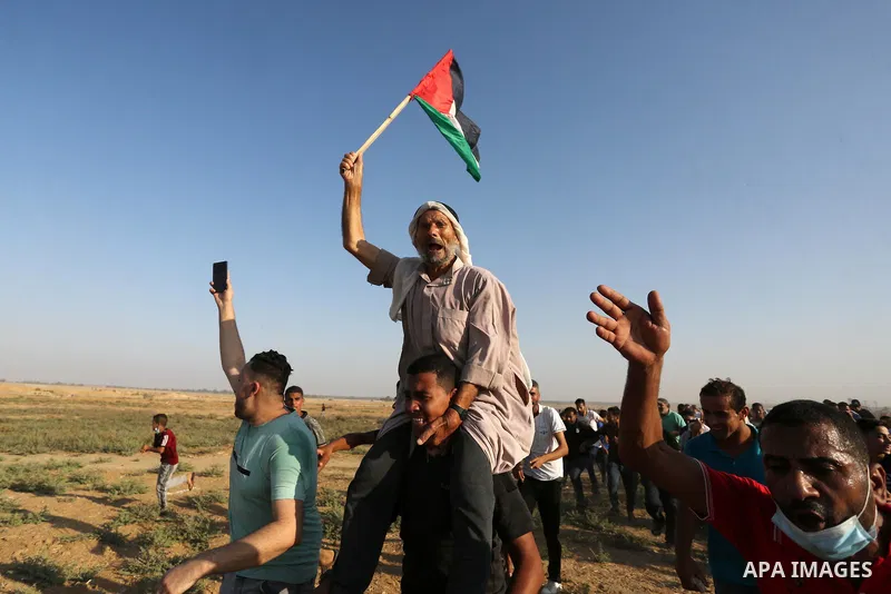 Palestinian demonstrators gather during a protest along the border fence, east of Khan Yunis in the southern Gaza Strip, on August 25, 2021. Palestinian groups in Gaza have pledged to continue protests along the border t...