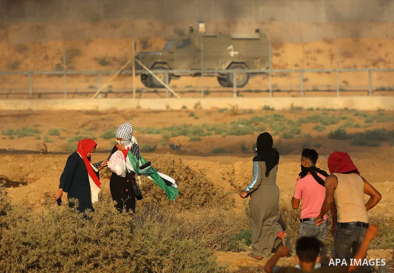 Palestinian demonstrators gather during a protest along the border fence, east of Khan Yunis in the southern Gaza Strip, on August 25, 2021. Palestinian groups in Gaza have pledged to continue protests along the border t...