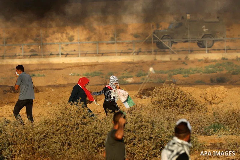 Palestinian demonstrators gather during a protest along the border fence, east of Khan Yunis in the southern Gaza Strip, on August 25, 2021. Palestinian groups in Gaza have pledged to continue protests along the border t...