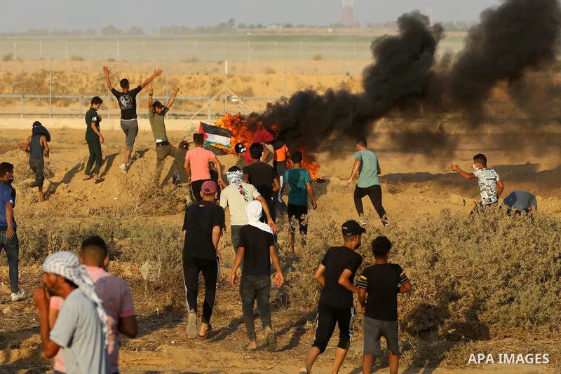 Palestinian demonstrators gather during a protest along the border fence, east of Khan Yunis in the southern Gaza Strip, on August 25, 2021. Palestinian groups in Gaza have pledged to continue protests along the border t...