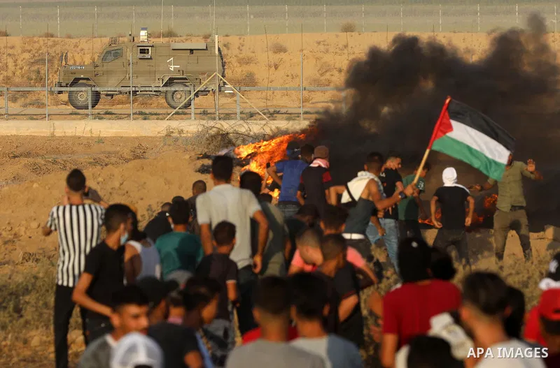 Palestinian demonstrators gather during a protest along the border fence, east of Khan Yunis in the southern Gaza Strip, on August 25, 2021. Palestinian groups in Gaza have pledged to continue protests along the border t...