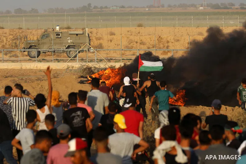 Palestinian demonstrators gather during a protest along the border fence, east of Khan Yunis in the southern Gaza Strip, on August 25, 2021. Palestinian groups in Gaza have pledged to continue protests along the border t...