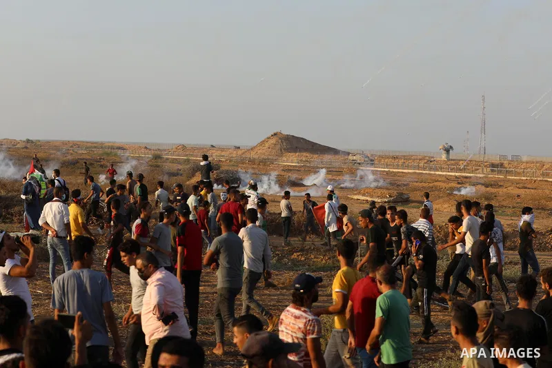 Palestinian demonstrators gather during a protest along the border fence, east of Khan Yunis in the southern Gaza Strip, on August 25, 2021. Palestinian groups in Gaza have pledged to continue protests along the border t...