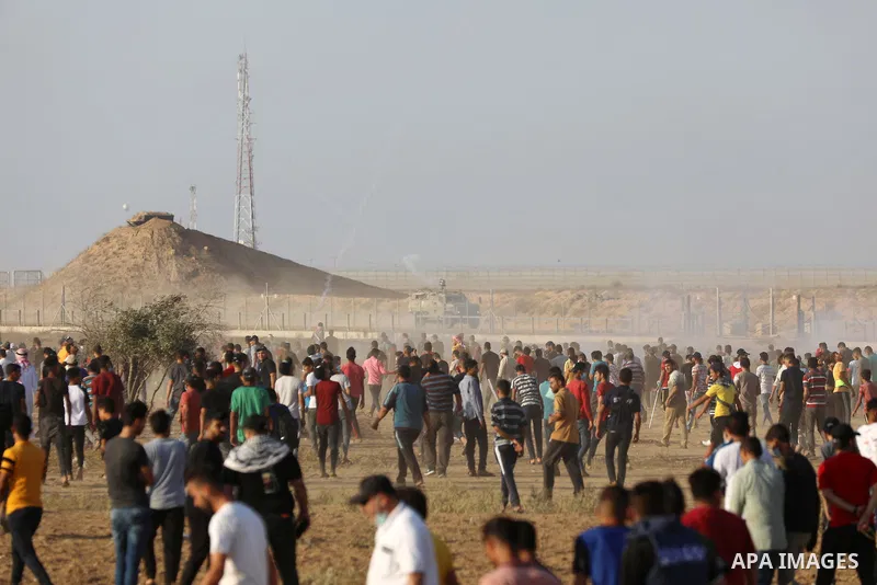 Palestinian demonstrators gather during a protest along the border fence, east of Khan Yunis in the southern Gaza Strip, on August 25, 2021. Palestinian groups in Gaza have pledged to continue protests along the border t...