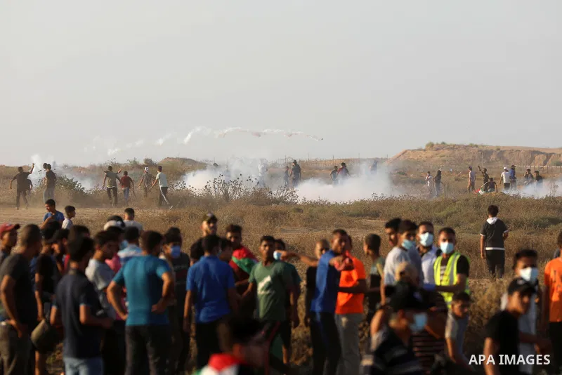 Palestinian demonstrators gather during a protest along the border fence, east of Khan Yunis in the southern Gaza Strip, on August 25, 2021. Palestinian groups in Gaza have pledged to continue protests along the border t...