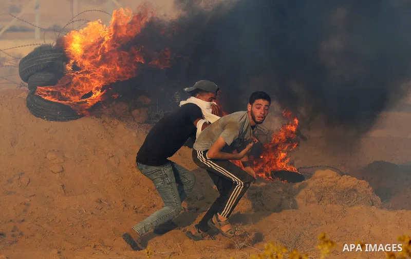 Palestinian demonstrators gather during a protest along the border fence, east of Khan Yunis in the southern Gaza Strip, on August 25, 2021. Palestinian groups in Gaza have pledged to continue protests along the border t...