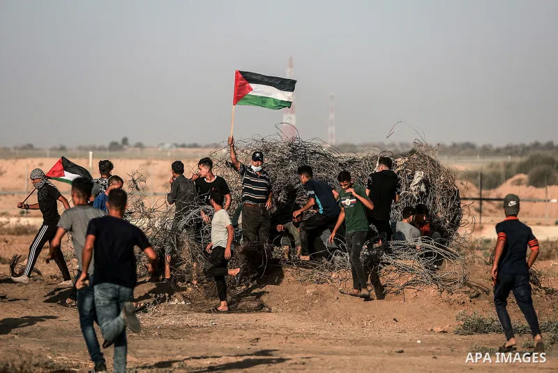 Palestinian demonstrators gather during a protest along the border fence, east of Khan Yunis in the southern Gaza Strip, on August 25, 2021. Palestinian groups in Gaza have pledged to continue protests along the border t...