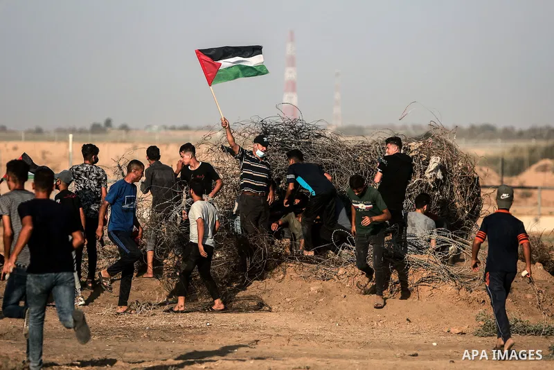 Palestinian demonstrators gather during a protest along the border fence, east of Khan Yunis in the southern Gaza Strip, on August 25, 2021. Palestinian groups in Gaza have pledged to continue protests along the border t...