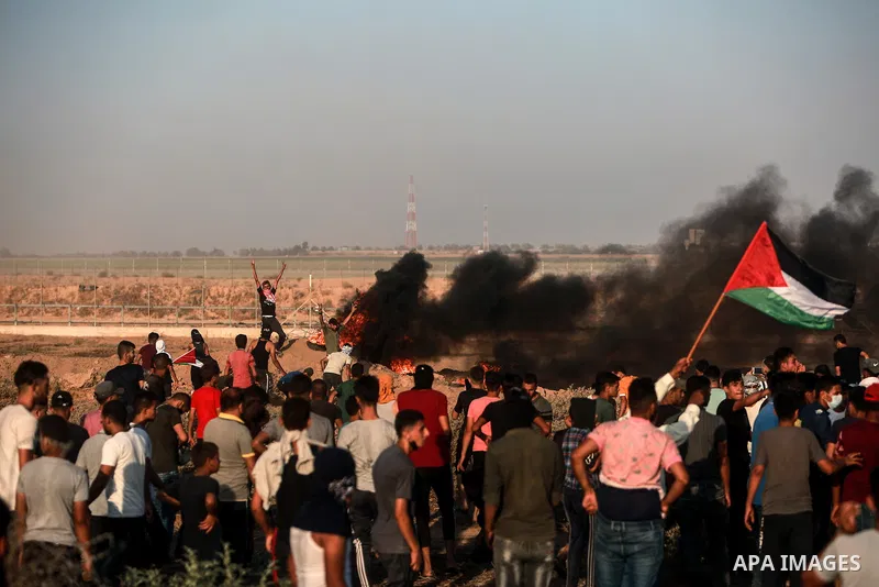 Palestinian demonstrators gather during a protest along the border fence, east of Khan Yunis in the southern Gaza Strip, on August 25, 2021. Palestinian groups in Gaza have pledged to continue protests along the border t...