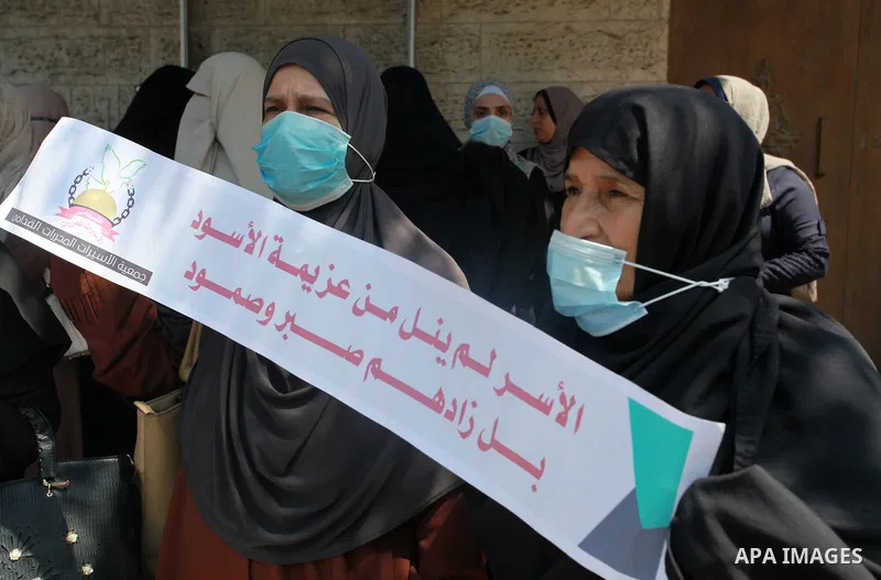 Palestinians take part in a protest to show solidarity with prisoner Anhar al-Deek, in front of the headquarters of Red cross, in Gaza city, on August 26, 2021. Anhar al-Deek, a 25-year-old Palestinian prisoner, is getti...