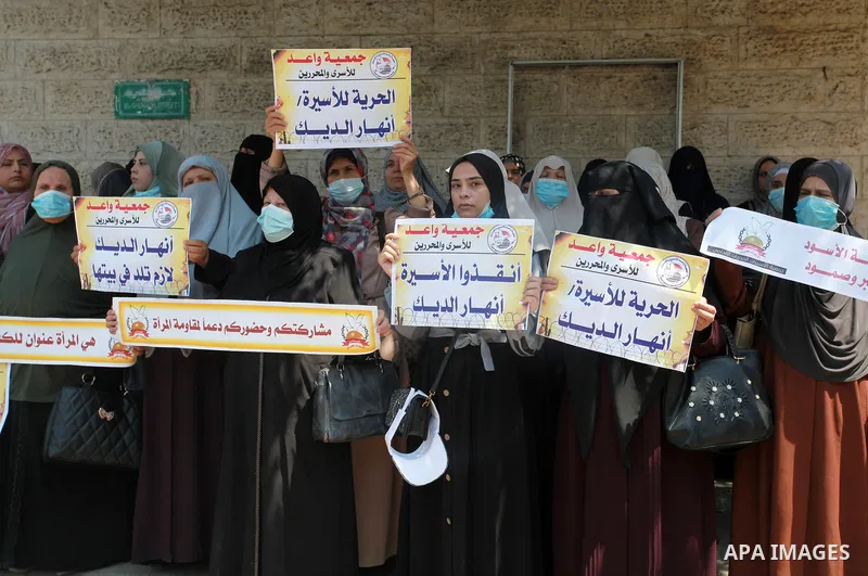 Palestinians take part in a protest to show solidarity with prisoner Anhar al-Deek, in front of the headquarters of Red cross, in Gaza city, on August 26, 2021. Anhar al-Deek, a 25-year-old Palestinian prisoner, is getti...