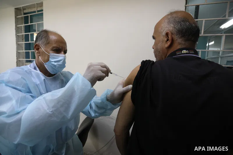 Palestinians get inoculated with a dose of the Covishield vaccine against the Covid-19 coronavirus, at a temporary vaccination centre set up, in Deir Al Balah in the center of Gaza strip on August 26, 2021. Minister of H...