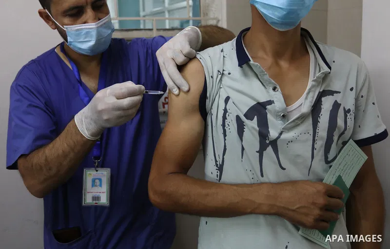 Palestinians get inoculated with a dose of the Covishield vaccine against the Covid-19 coronavirus, at a temporary vaccination centre set up, in Deir Al Balah in the center of Gaza strip on August 26, 2021. Minister of H...