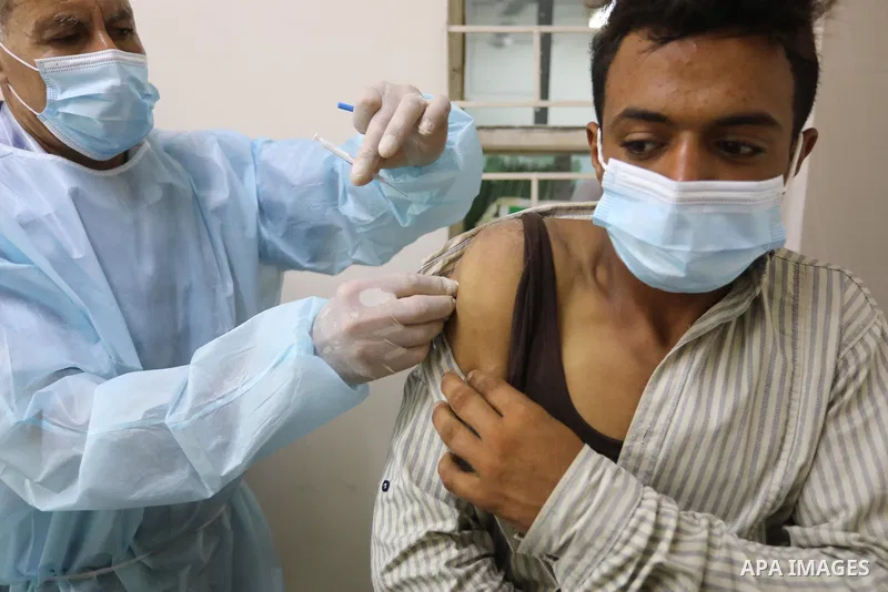 Palestinians get inoculated with a dose of the Covishield vaccine against the Covid-19 coronavirus, at a temporary vaccination centre set up, in Deir Al Balah in the center of Gaza strip on August 26, 2021. Minister of H...