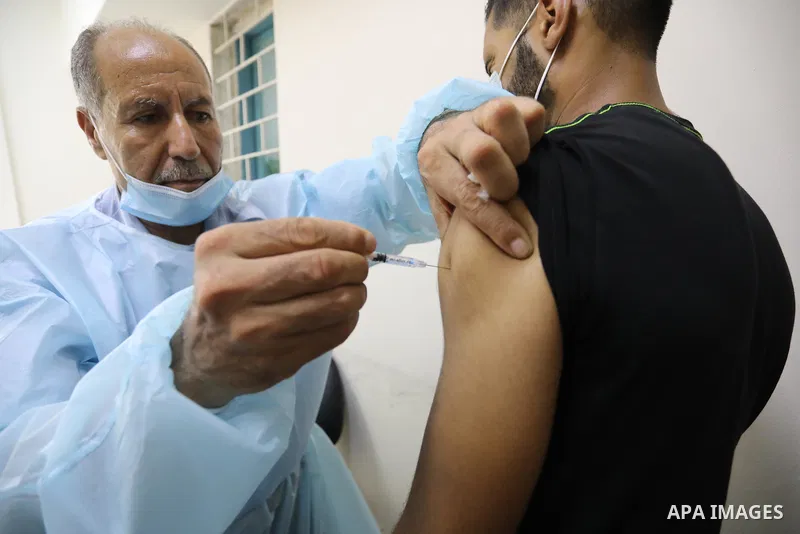 Palestinians get inoculated with a dose of the Covishield vaccine against the Covid-19 coronavirus, at a temporary vaccination centre set up, in Deir Al Balah in the center of Gaza strip on August 26, 2021. Minister of H...