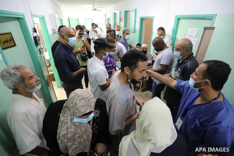 Palestinians get inoculated with a dose of the Covishield vaccine against the Covid-19 coronavirus, at a temporary vaccination centre set up, in Deir Al Balah in the center of Gaza strip on August 26, 2021. Minister of H...